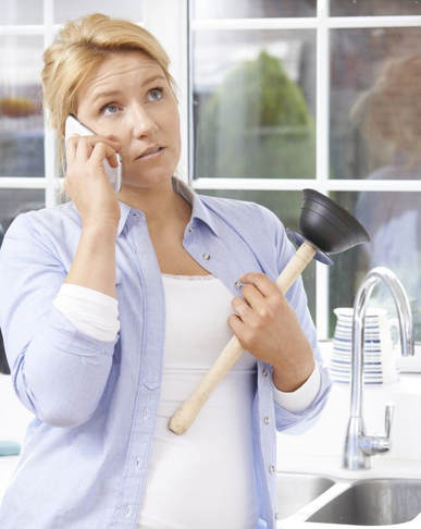 Woman with clogged sink on phone 
