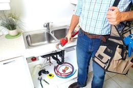 plumber with tools and sink 