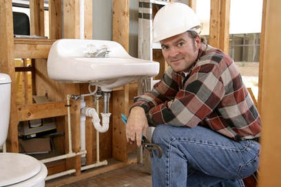 plumber working on new sink 